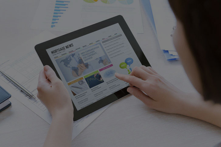 mortgage-news.jpg woman reading mortgage news on tablet