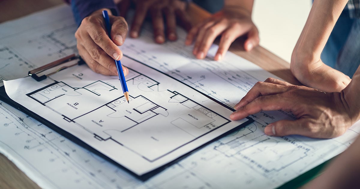 Architect & Engineer working drawing document about project planning and progress of work schedule on the home building construction site