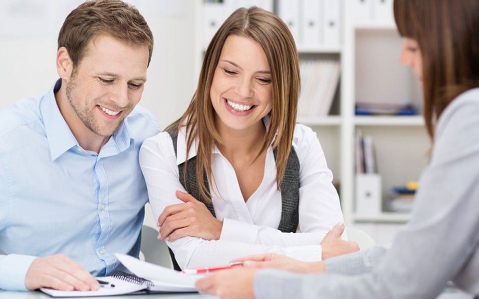 couple working with mortgage loan officer