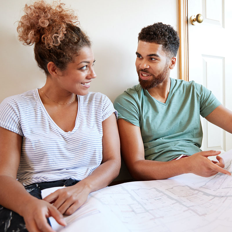 couple looking at renovation blueprints
