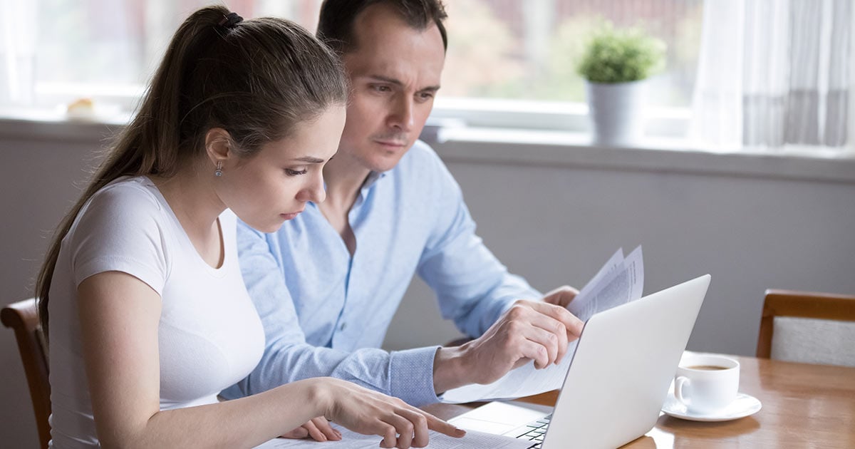 couple studying contract for new house before signing couple studying contract for new house before signing