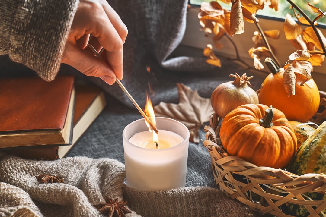 hand-with-burning-match-lighting-a-candle-on-windo-2023-11-27-05-31-41-utc-WEB