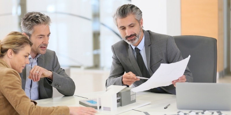 Mortgage worker showing documents