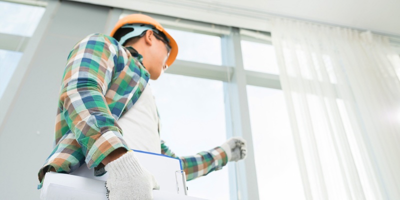 construction inspector looking at house