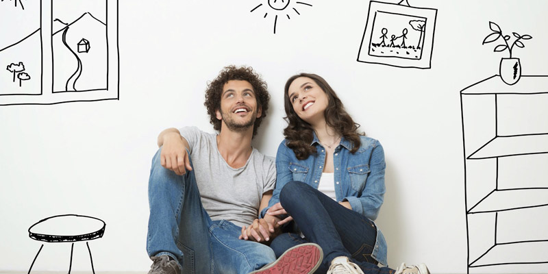 Couple sits in cartoon painted room