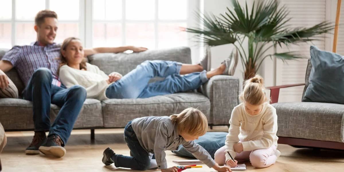 family-in-living-room-with-kids-playing