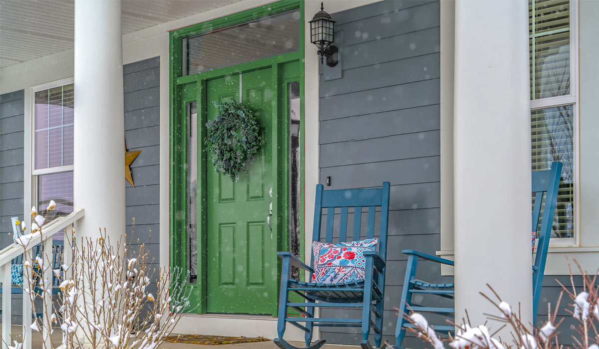 front of home with snow filled porch