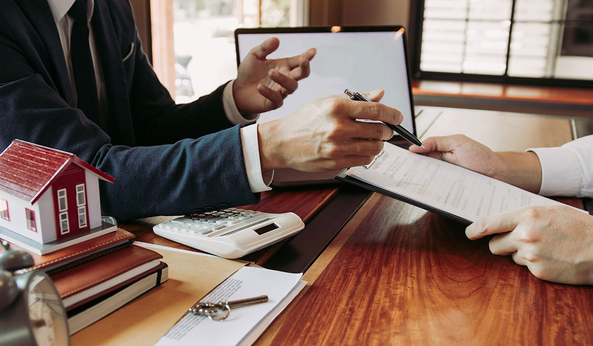 man being handed signing papers for home sale