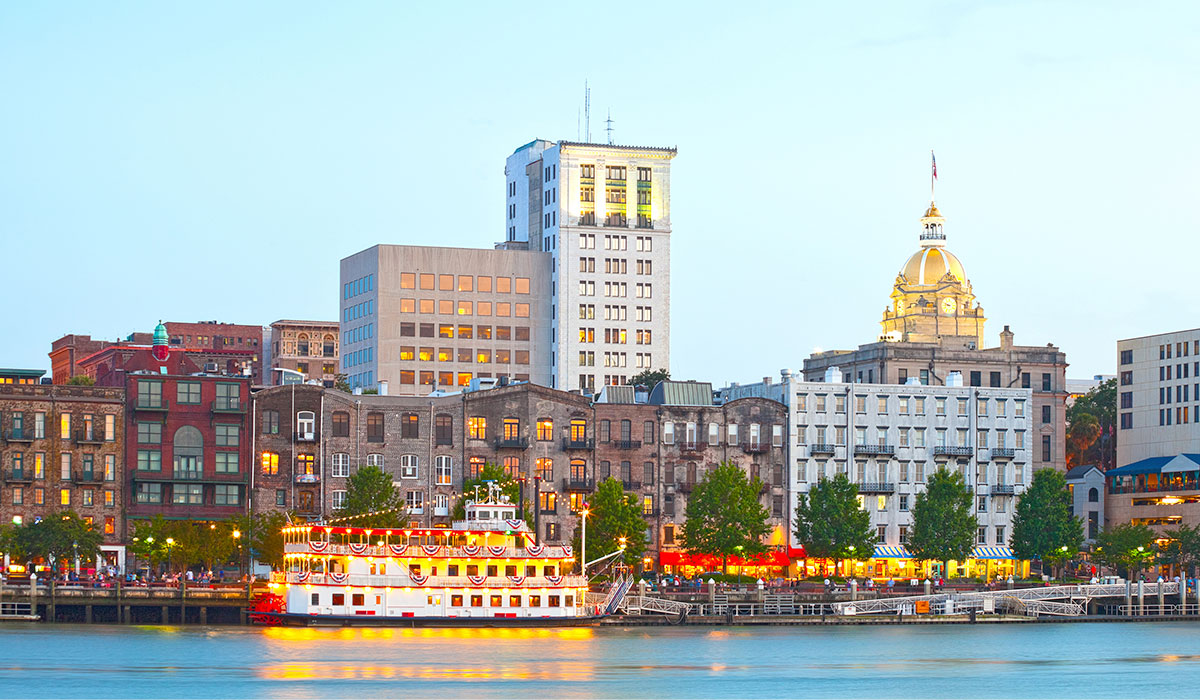 skyline of historic downtown Savannah Georgia with a steam boat and buildings