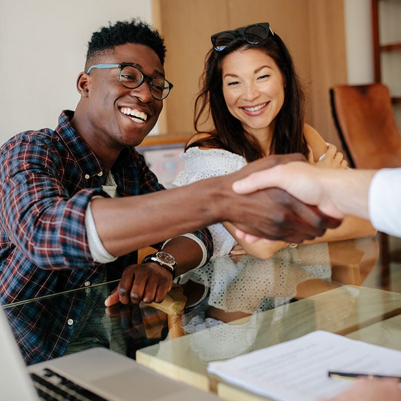 interracial-couple-shaking-hands-with-loan-officer