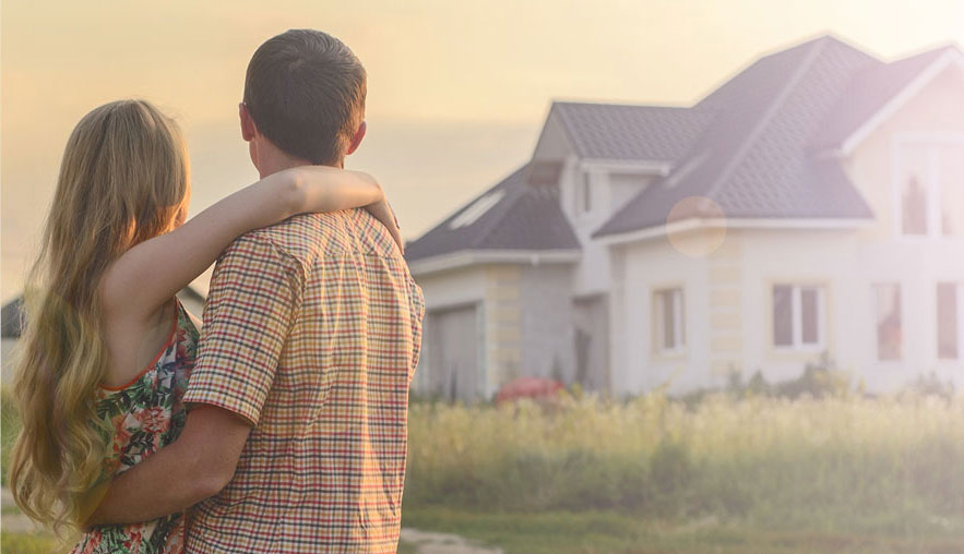 couple standing outisde in front of home
