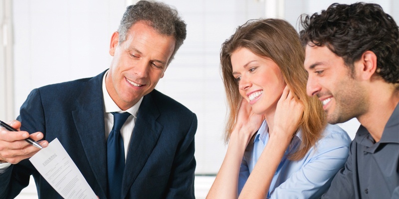 Couple speaking with agent about mortgage information