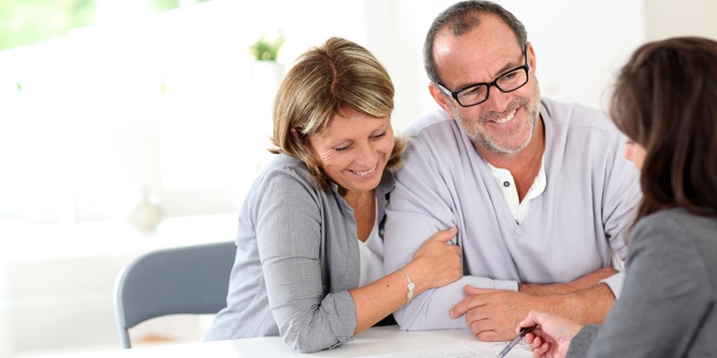 Couple talking to mortgage broker about house