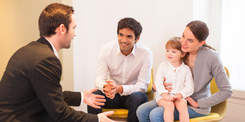 Diverse family with daughter speaking to mortgage broker