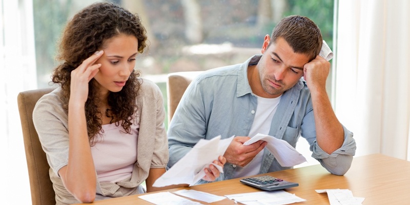 couple stressed while doing taxes